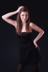 Fototapeta na wymiar Beautiful young woman in black dress