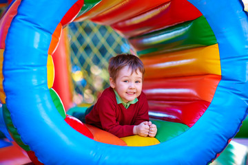Fototapeta na wymiar happy kids playing on inflatable attraction playground
