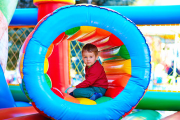 Fototapeta na wymiar happy kids playing on inflatable attraction playground