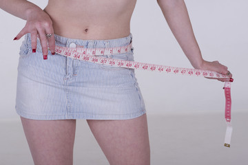 Woman checking her waist measurement