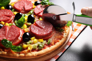 Pizza with tomato, salami, olives and basil