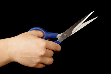Female hand holding scissors isolated