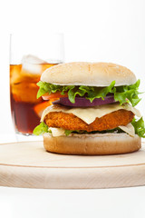Chickenburger and glass of cola with ice