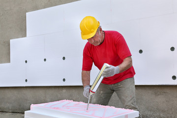 Construction site, polystyrene insulation glue applying
