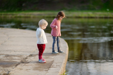 Two cute sisters by a river