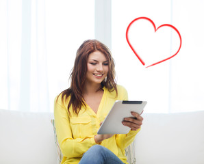 smiling woman with tablet pc computer at home