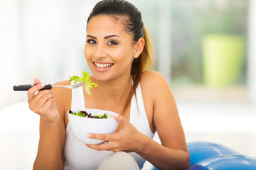 healthy woman eating green salad