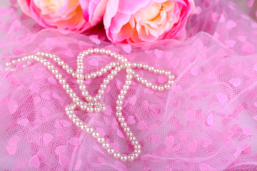 Beautiful pearls on pink cloth