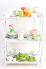 Different tableware on shelf, isolated on white