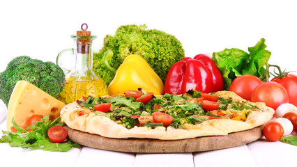 Tasty vegetarian pizza and vegetables on wooden table