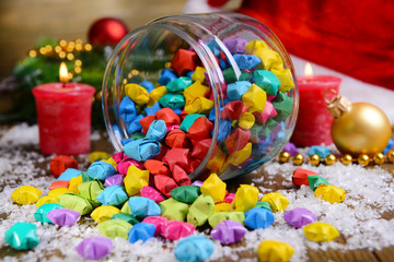 Paper stars with dreams in jar on table close-up