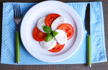 Caprese salad with mozarella cheese, tomatoes and basil