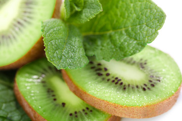 Fototapeta na wymiar Kiwi fruit with mint leaves, close up