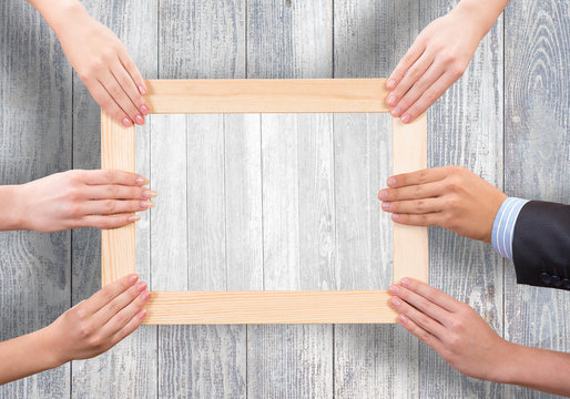 Hands holding frame