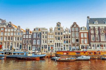 Beautiful view of Amsterdam canals with bridge and typical dutch