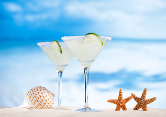 margarita  cocktail on beach, blue sea and sky background