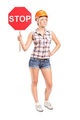 Female construction worker holding a stop sign