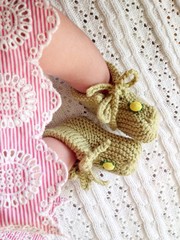 Fototapeta na wymiar tiny newborn babys feet and shoes