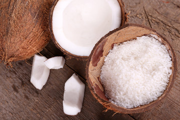 Broken coconut on wooden background