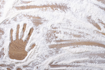 female palm print on flour scattered
