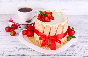Tasty cake Charlotte with fresh strawberries on wooden table