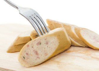 Sausage on a fork and cutting board
