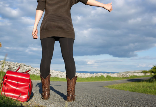 Woman with bag hitchhiking