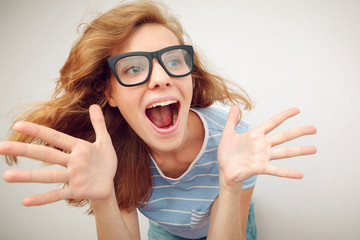 Portrait of Funny redhead girl with open hands - wide lens effec