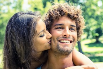Fototapeta premium Cute couple relaxing on park bench