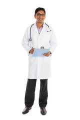 indian male doctor full body writing on board isolated on white