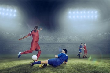 Obraz na płótnie Canvas Composite image of football players tackling for the ball