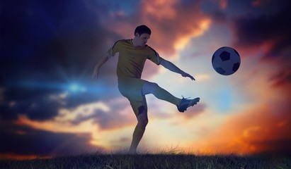 Fototapeta na wymiar Composite image of football player in yellow kicking