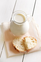 Fresh milk in jug and bread