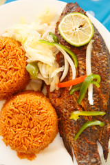 Jollof rice, popular food of Ghana with Tilapia famous local fish
