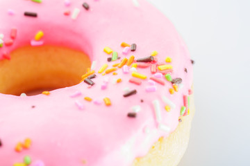 Pink Iced Doughnut covered in sprinkles  delicious  vivid