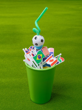 Drinking Straw In Green Cup With Many Nation Flag