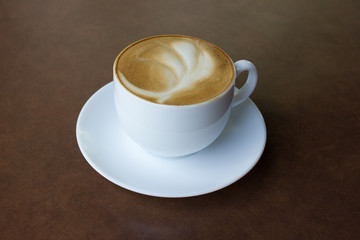 Cup of art latte on a cappuccino coffee