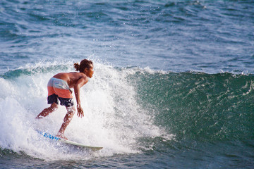 Surfer on Blue Ocean Wave in Bali