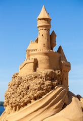 A beautiful sculpture of sand castle against blue sky