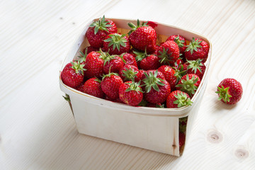 many strawberries in a wooden basket