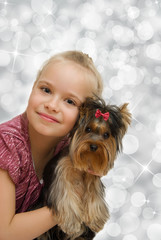 Young girl with cute Yorkshire terrier - best friends