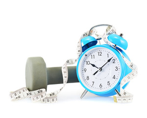 Centimeter tape, clock and dumbbell