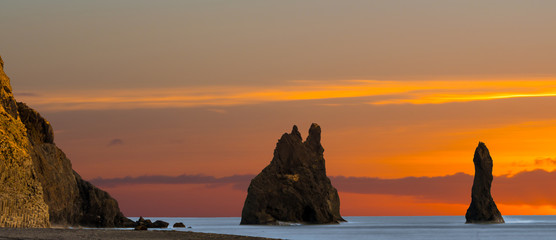 Rock outcroppings along shoreline at sunset
