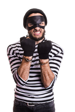 Angry burglar with handcuffs