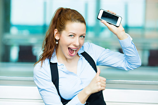 Portrait excited businesswoman with smart phone