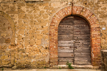 Old wooden door and brick wall