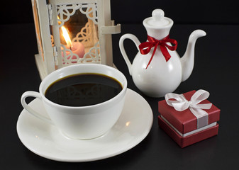 Cup of coffee with lantern and gift box