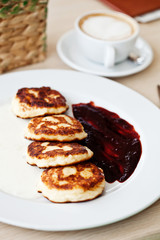 Cheese pancakes with sour cream and jam