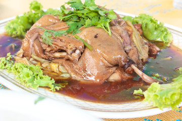 Baked duck stuffed with chinese flowers.