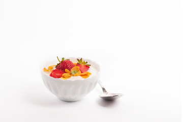 White yogurt with fresh strawberries and cornflakes
